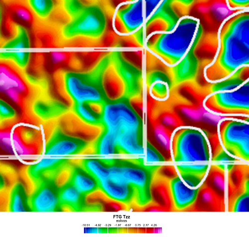 Air-FTG® Tzz component over Luconia. White polygons locate known carbonate build-ups; purple line locates composite seismic line shown in Figure 2.